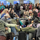 Travelers wait to board a plane at Miami International Airport in Miami, Florida, on April 22, 2022.